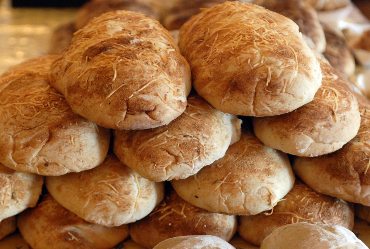 Freshly baked loaves of herb garlic bread are displayed at the Arabesque  Bakery booth at the Millwood Farmers Market. All the ingredients used to bake the bread are organic, and the wheat flour must be bought in Montana because it’s difficult to find in Washington.  (J. Bart Rayniak / The Spokesman-Review)