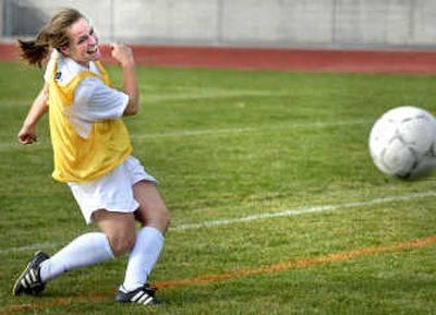 University High School senior midfielder Abby Goss sends a ball flying toward the goal during varsity soccer practice. 
 (Holly Pickett / The Spokesman-Review)