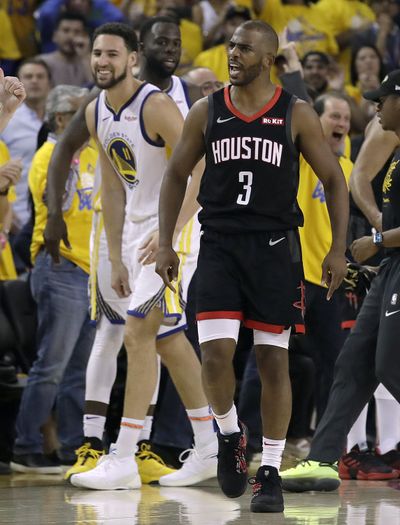 Golden State Warriors guard Klay Thompson, left, smiles as Houston Rockets guard Chris Paul (3) is ejected during the second half of Game 1 of a second-round NBA basketball playoff series in Oakland, Calif., Sunday, April 28, 2019. (Jeff Chiu / Associated Press)
