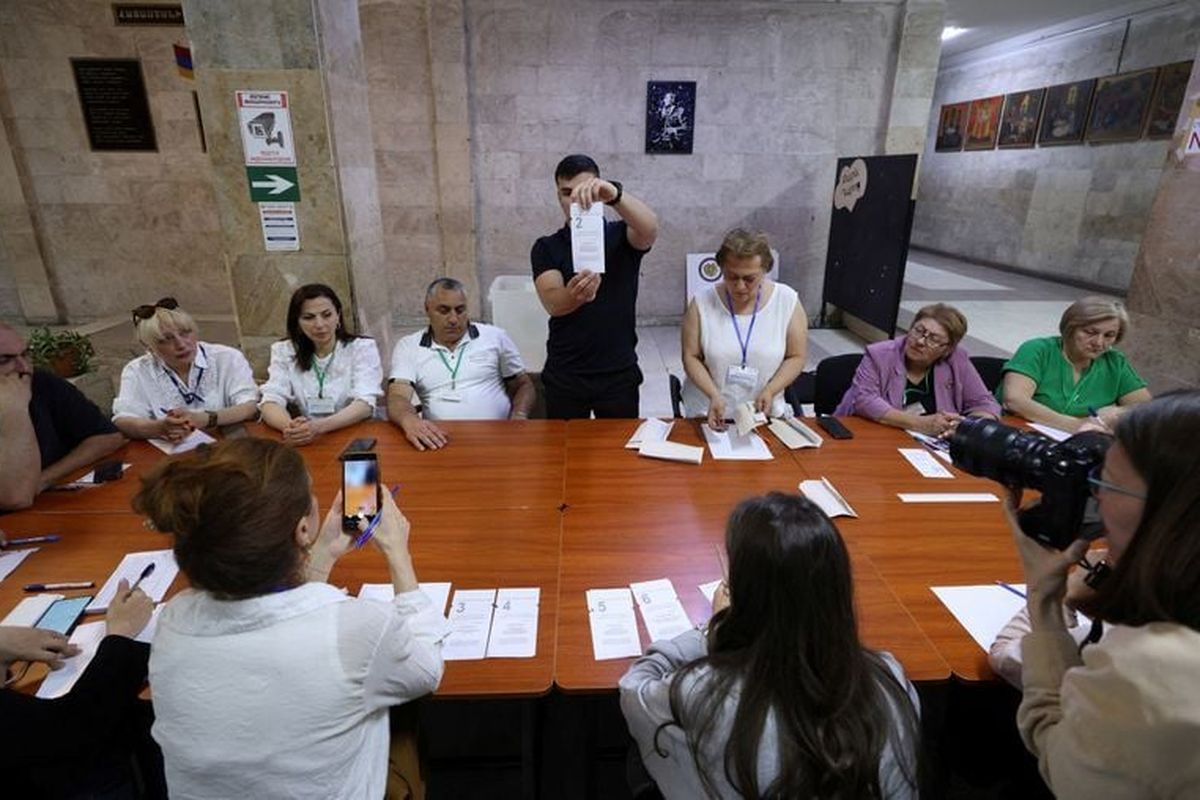 Members of an electoral commission count votes after polling stations closed in a parliamentary election on Sunday in Yerevan, Armenia.   (Reuters )