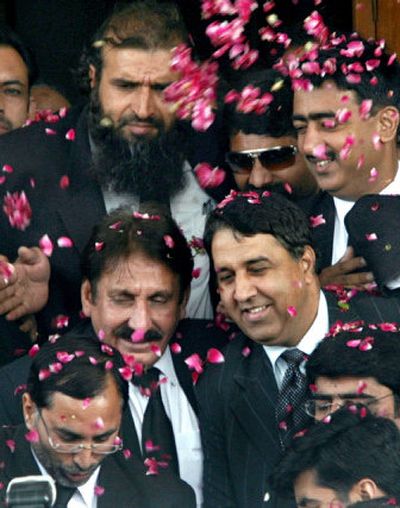 
Pakistani lawyers shower rose petals on the suspended Pakistani Chief Justice Iftikhar Mohammed Chaudhry, center.
 (Associated Press / The Spokesman-Review)