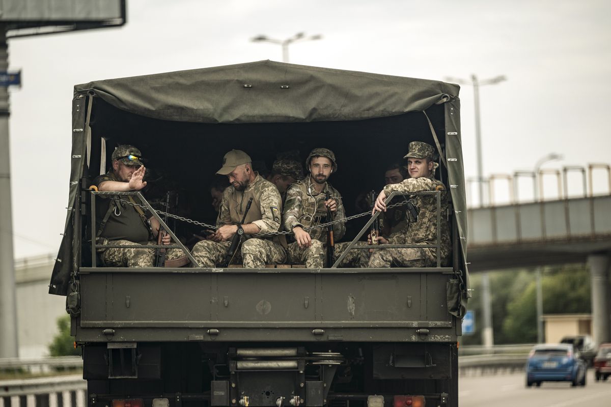 Ukrainian soldiers ride in the back of a truck in the Kyiv region of Ukraine on Aug. 27, 2022. (Lynsey Addario/The New York Times) -- NO SALES --  (LYNSEY ADDARIO)