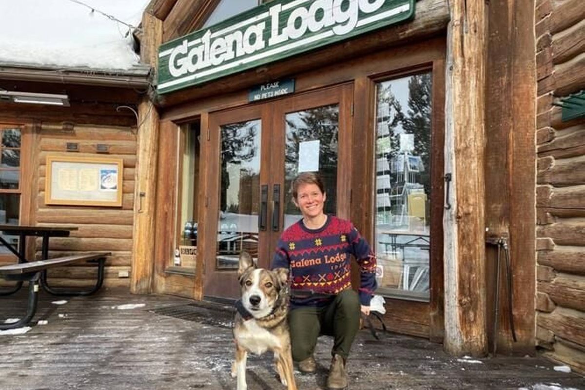 Rio, the Galena Lodge “loaner dog,” poses on the deck outside the lodge with his new owner, Chelan Oldemeyer, on Jan. 26. (Nicole Blanchard/Idaho Statesman)