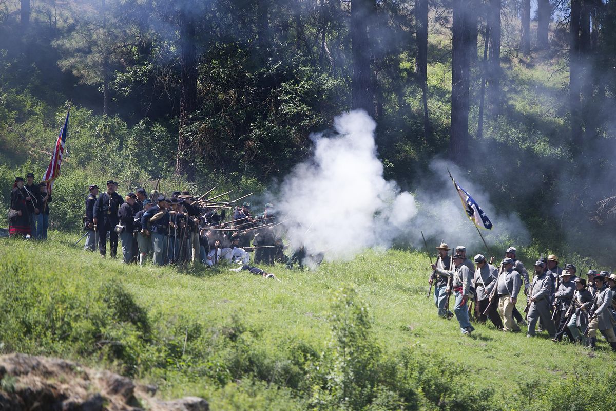 Civil War re-enactors playing the Confederacy and the Union take shots at each other during the Deep Creek Civil War Re-enactment on Monday at Deep Creek Farms outside Spokane. (Tyler Tjomsland / The Spokesman-Review)