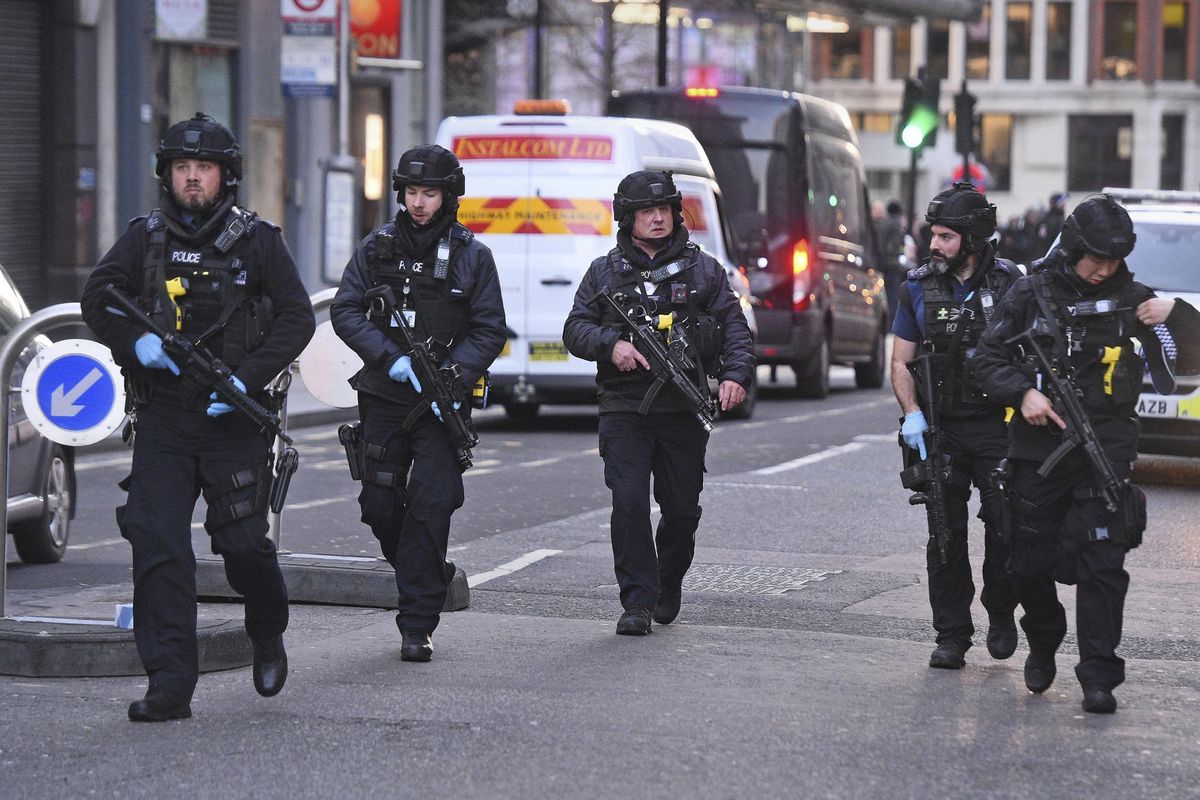 Police on Cannon Street in London near the scene of an incident on London Bridge in central London following a police incident, Friday, Nov. 29, 2019. British police cleared the area around London Bridge in the center of the British capital on Friday after a stabbing and shooting incident that left several people injured. (Kirsty O