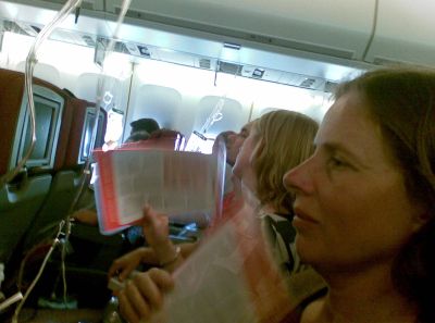 Travelers aboard the Qantas plane fan themselves amid oxygen masks dropped from overhead panels in this photo taken by a passenger. (Associated Press / The Spokesman-Review)
