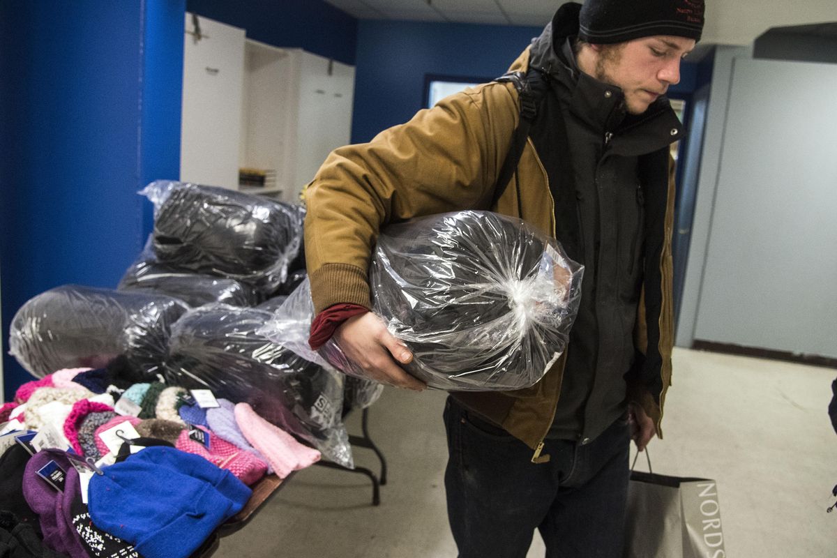 Brandon Vornhader chose a sleeping bag for a Christmas gift at the Crosswalk Christmas Party, Thursday night, Dec. 21, 2017, in Spokane, Wash. (Dan Pelle / The Spokesman-Review)