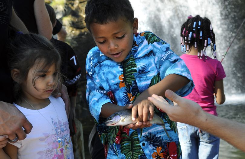 Dylan Stevens, of Medical Lake, shows a rainbow trout he caught at Mirabeau Falls, to his sister, Rheese, last year during Valleyfest. The Mirabeau Falls will be stocked for fishing at the 21st annual Valleyfest this weekend. (File photos)