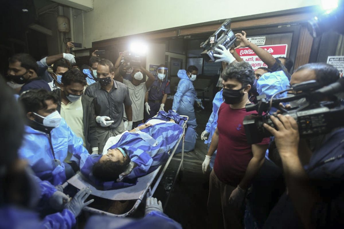 One of the persons injured after an Air India Express flight skidded off a runway while landing at the Kozhikode airport is brought for treatment to the Medical College Hospital in Kozhikode, Kerala state, India, Friday, Aug. 7, 2020.  (STR)