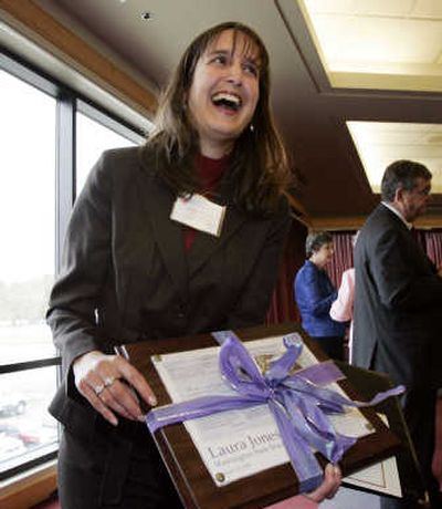 
Laura Jones, of Pasco High School, smiles as she holds her teacher of the year award. Associated Press
 (Associated Press / The Spokesman-Review)