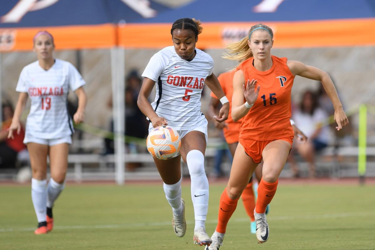 Gonzaga forward Giana Riley, who scored a hat trick, tries to maintain control of the ball Saturday against Pepperdine defender Taylor Bloom in Malibu, California.  (Courtesy of Gonzaga Athletics)