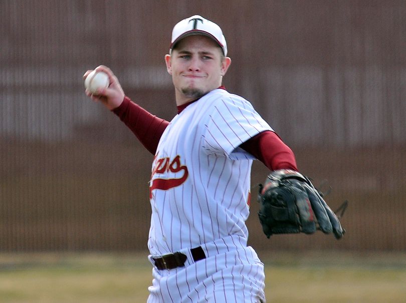 Taylor Keeton prepares to throw to first base from third at University High School. The Titan standout and his team were playing the Mt. Spokane Wildcats. (Jesse Tinsley)