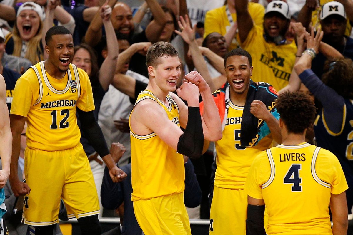 Michigan’s Moritz Wagner, second from left, celebrates with his teammates during the second half  Saturday  in San Antonio. (Brynn Anderson / AP)