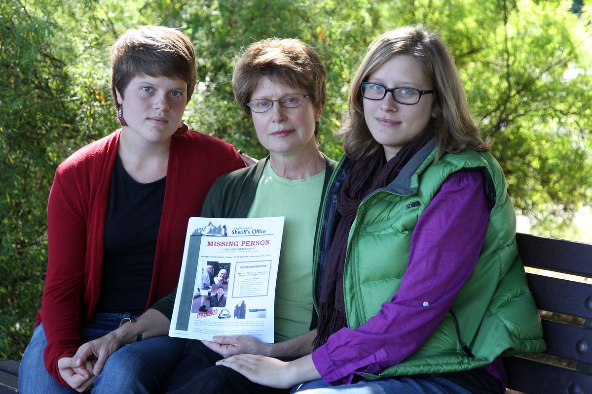 Julie Bosworth, center, sits with her daughters Claire, left, and Kelly before hanging missing person fliers Wednesday, Sept. 28, 2011, in Portland, Ore.Nearly two weeks after Mark Bosworth vanished during a seven-day bicycle tour along scenic roads in Oregon, police still have no idea where the 54-year-old cancer survivor went. He left everything behind: clothing, his wallet and credit cards, and his bike. Relatives are convinced Bosworth is alive, maybe so confused that he has forgotten that his home is in Portland. (Rick Bowmer / Associated Press)