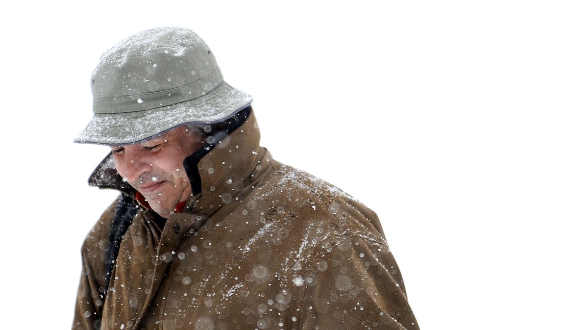 Resident Edward Lawlor braves the snowy weather while walking along Sherman Avenue in Coeur d’Alene on Monday. (Kathy Plonka)