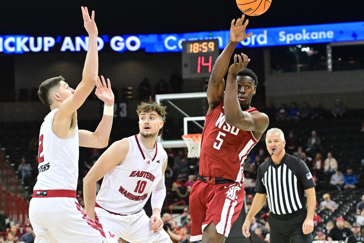 Washington State guard TJ Bamba, right, passes against Eastern Washington during a nonconference game Nov. 21 at the Spokane Arena.  (Tyler Tjomsland/The Spokesman-Review)