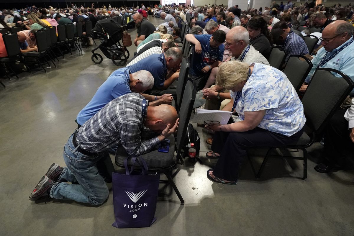 People pray during the annual Southern Baptist Convention meeting Tuesday, June 15, 2021, in Nashville, Tenn.  (Mark Humphrey)