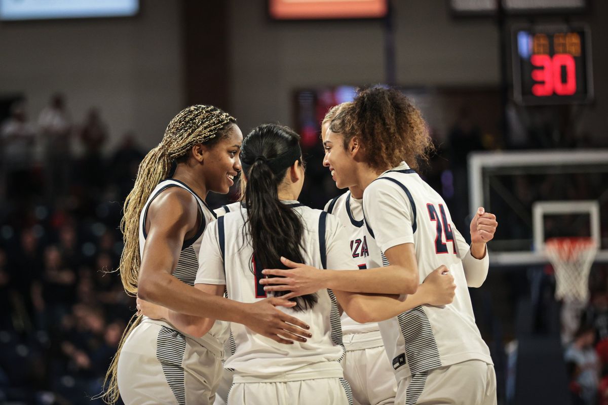 Gonzaga players, from left, Yvonne Ejim, Kaylynne Truong and McKayla Williams huddle with teammates during a West Coast Conference game against Saint Mary