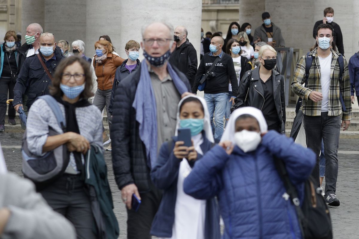 Faithful and nuns wear face masks to stop the spread of COVID-19, at the Vatican, Tuesday, Oct. 6, 2020. Italy