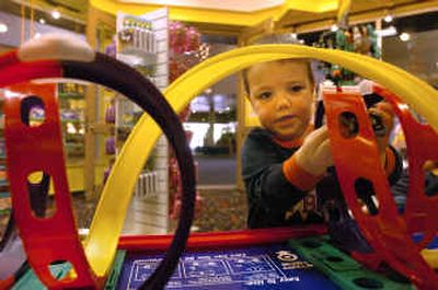 
Marco Ferci, 3, of Gresham, Ore., plays with a toy racetrack at Tinkerz, the new toy store in the Plaza Shops in Coeur d'Alene.
 (Jesse Tinsley / The Spokesman-Review)
