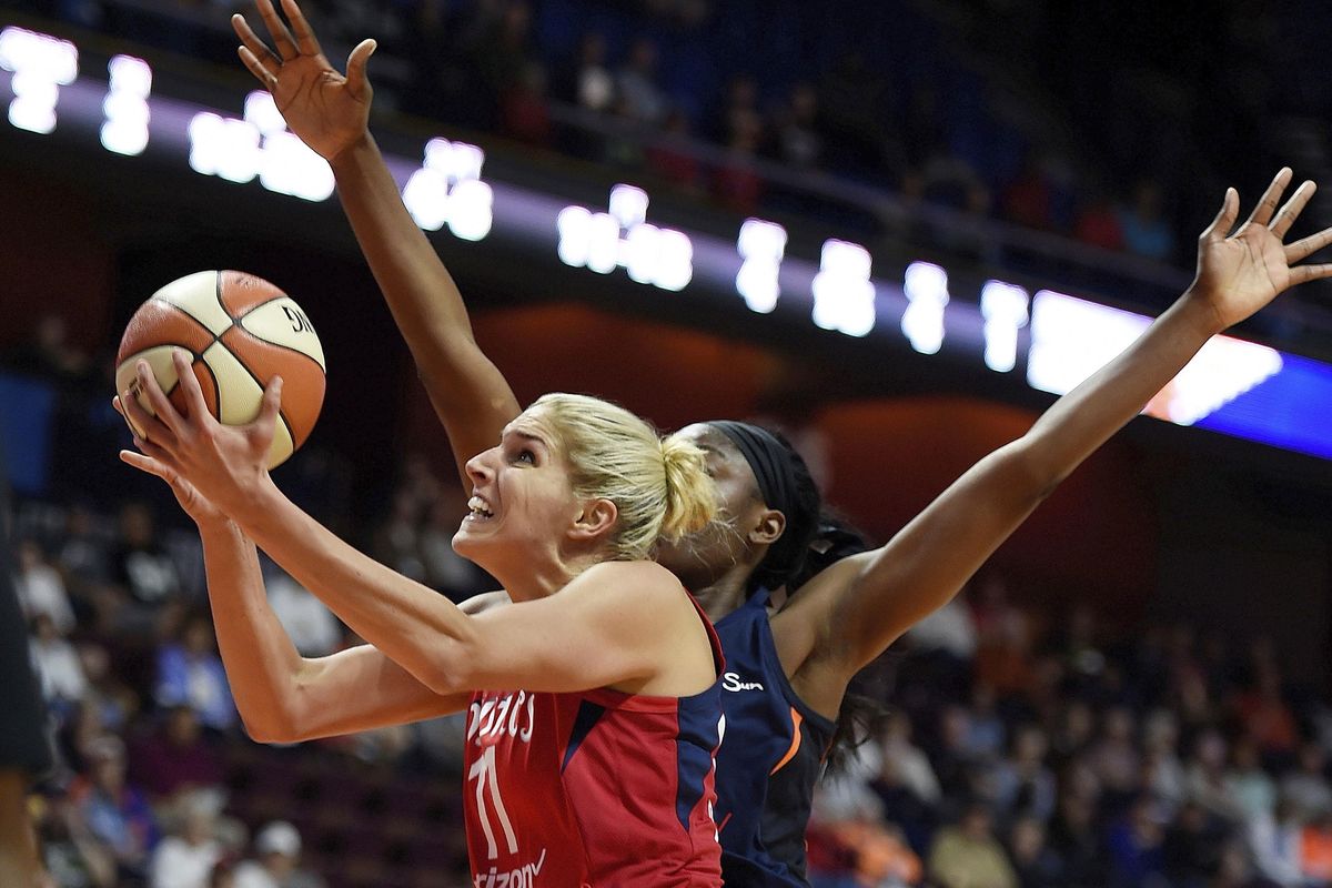 Washington Mystics forward Elena Delle Donne  shoots past Connecticut Sun forward Chiney Ogwumike during the first half of a WNBA basketball game in Uncasville, Conn. Many of the league’s top players, who will be playing in the All-Star Game this weekend in Minnesota, have come out over the past few years. WNBA players sexual orientation was rarely discussed in public when the league first started, but now is becoming a more important part of the league. (Sean D. Elliot / AP)