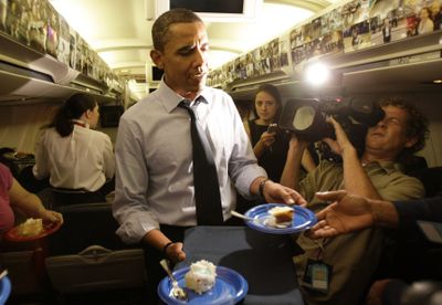 Democratic presidential candidate Sen. Barack Obama, D-Ill., serves birthday cake to the press corps while in flight Monday. (Associated Press / The Spokesman-Review)