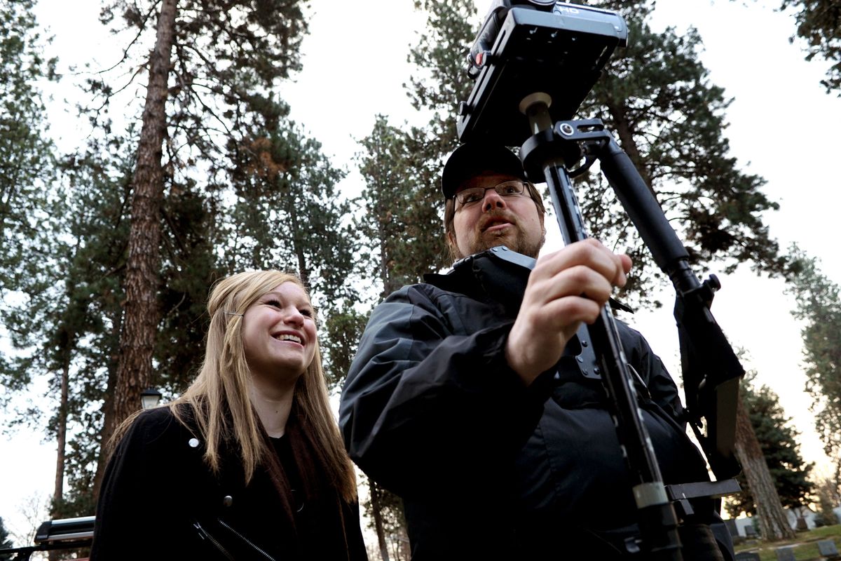 Coeur d’Alene High School 10th-grader Lauren Pinney, 15, gets some shooting tips from Dave McClave, co-owner of the Case42 video production company, at Forest Cemetery in Coeur d’Alene on Thursday. (Kathy Plonka)