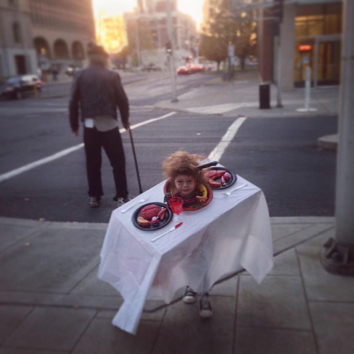 Audrey Alfaro’s then 2-year-old daughter shows off a head-on-a-platter illusion for Halloween in Spokane six years ago. (Audrey Alfaro / For The Spokesman-Review)
