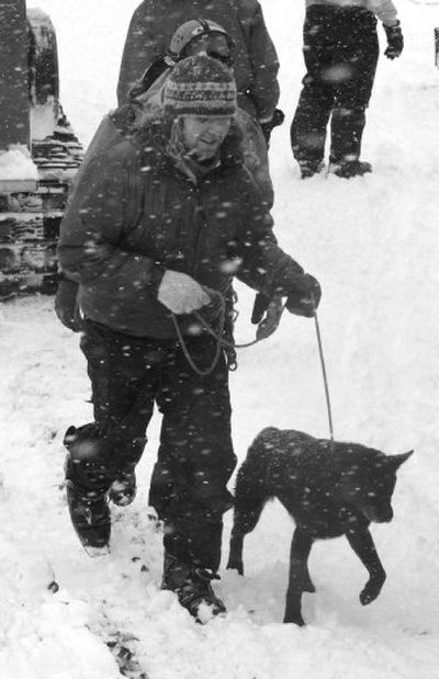 
Climber Matty Bryant, 34,  of Milwaukie, Ore.,  runs to an  ambulance  with a dog named Velvet near Government Camp, Ore., on Monday after being rescued from Mount Hood. Kate Hanlon, 34, of Wilsonville, Ore., and an unidentified woman were also rescued. 
 (Associated Press / The Spokesman-Review)