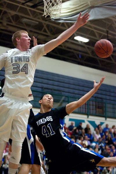 Lake City's Kyle Guice, left, and Coeur d'Alene's Chase Blakley battle for a rebound. (Bruce Twitchell)