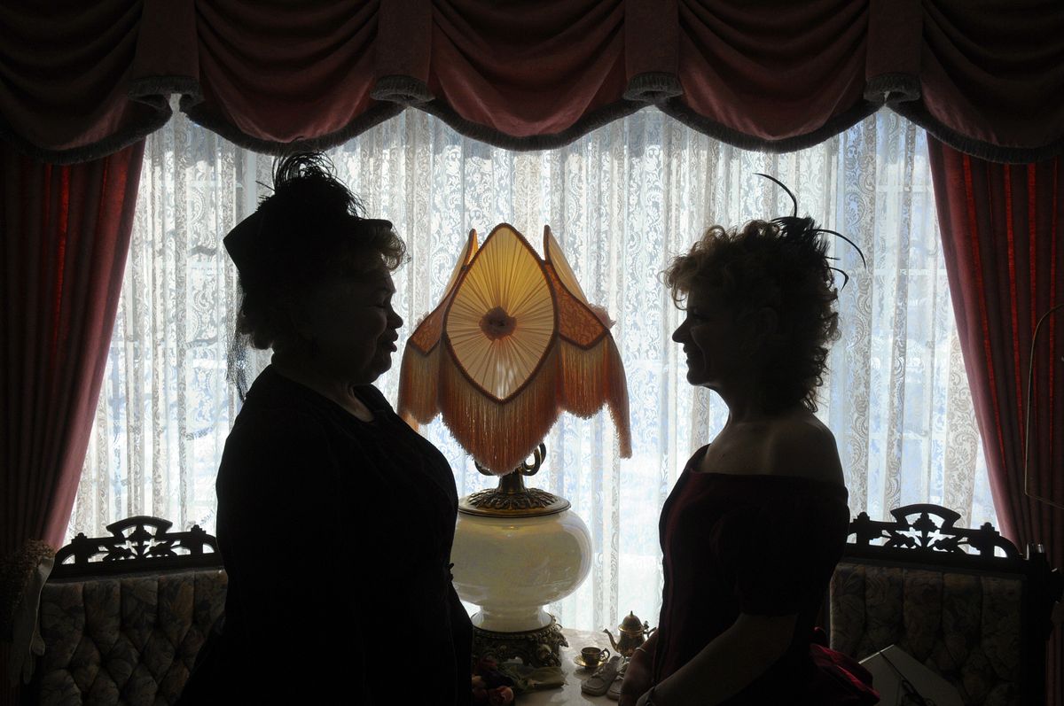 Ninna Gendreau, left, and Monique Hill are dressed for tea and framed in the living room window of the Gendreau home recently in Deer Park.  (Photos by Christopher Anderson / The Spokesman-Review)