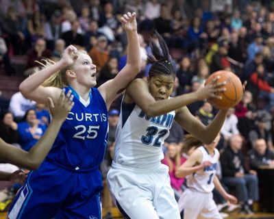 Gonzaga Prep's Otiona Gildon rips a rebound away from Curtis' Anna Matz in the first quarter on Saturday. (Dan Pelle)