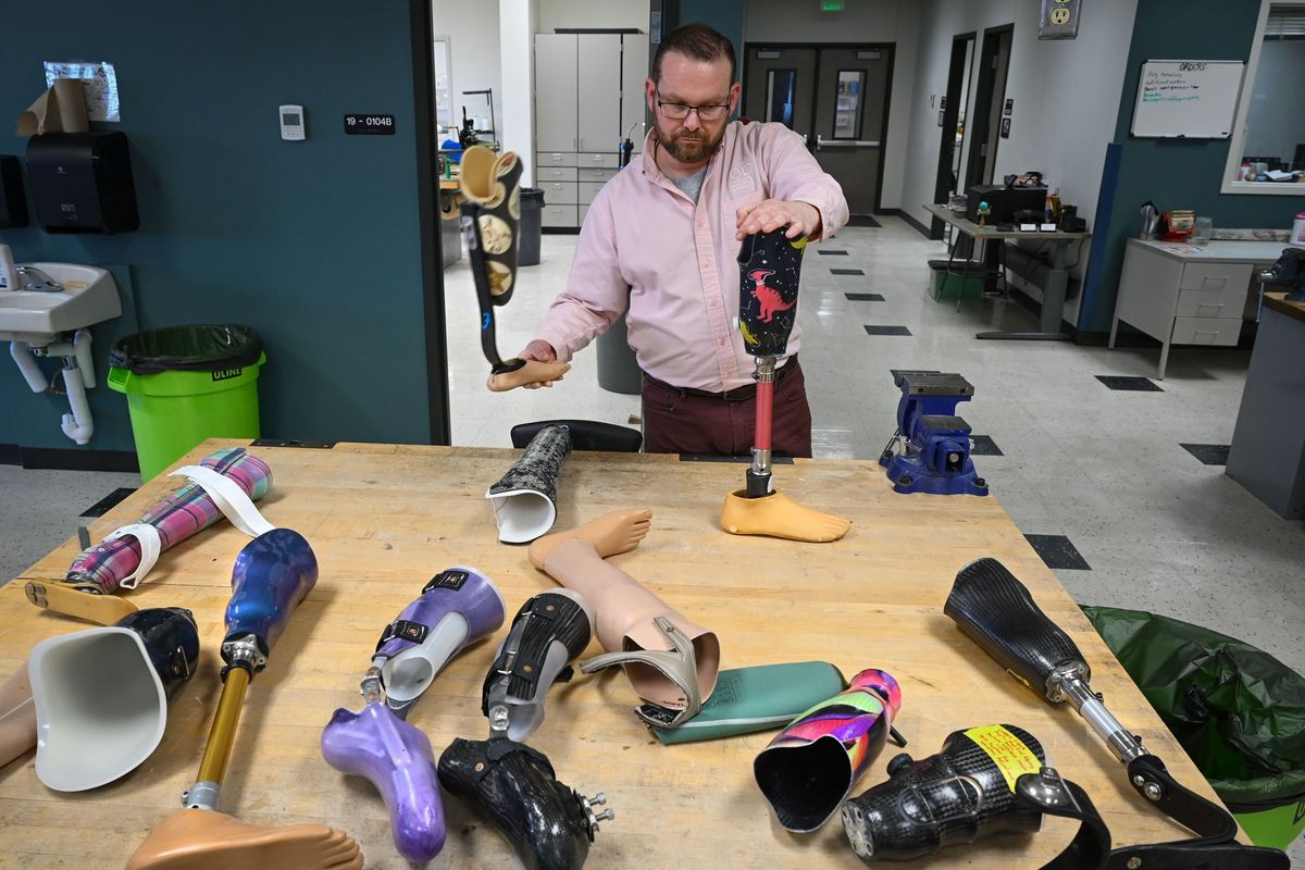 Ambrose Cavegn is the director of the Spokane Falls Orthotic and Prosthetic Science program. Here he demonstrates some of the work by his students.  (DAN PELLE/FOR THESPOKESMAN-REVIEW)