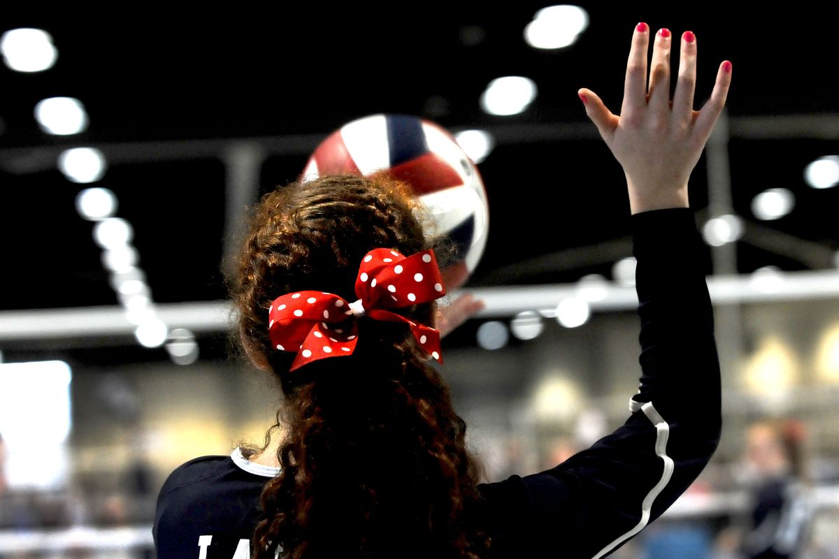 Ainsley Mattingly, of Lake Volleyball Club of Lake Stevens, Wash., serves during a Pacific Northwest Qualifier match Friday at the Spokane Convention Center. The tournament continues today at the Convention Center, Eastern Washington University and The Hub in Liberty Lake. (Kathy Plonka)