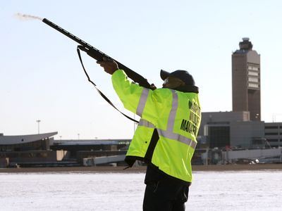 Wildlife technician Ulysses Dublin fires a nonlethal pyrotechnic round to disperse birds  Friday at Logan International Airport in Boston.  (Associated Press / The Spokesman-Review)