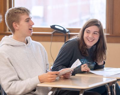 Miles Heath, left, and Bri Dashiell take part in a class discussion about probability in a statistics class Thursday, Nov. 13, 2019, at Lewis and Clark High School in Spokane. In the 2020 U.S. News and World Report’s top 100 high schools in the United States, LC is ranked 27th out of 17,790 public high schools. (Jesse Tinsley / The Spokesman-Review)