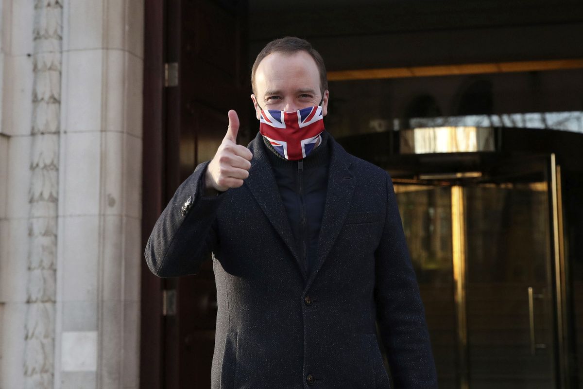 Heath Secretary Matt Hancock wears a face mask to curb the spread of COVID-19 and gives a thumbs up as he leaves Millbank in Westminster, central London, after the news that a COVID-19 vaccine from Oxford University and AstraZeneca has been approved for use in Britain, Wednesday, Dec. 30, 2020. Britain on Wednesday authorized use of a second COVID-19 vaccine, becoming the first country to greenlight an easy-to-handle shot that its developers hope will become the “vaccine for the world.”  (Steve Parsons)