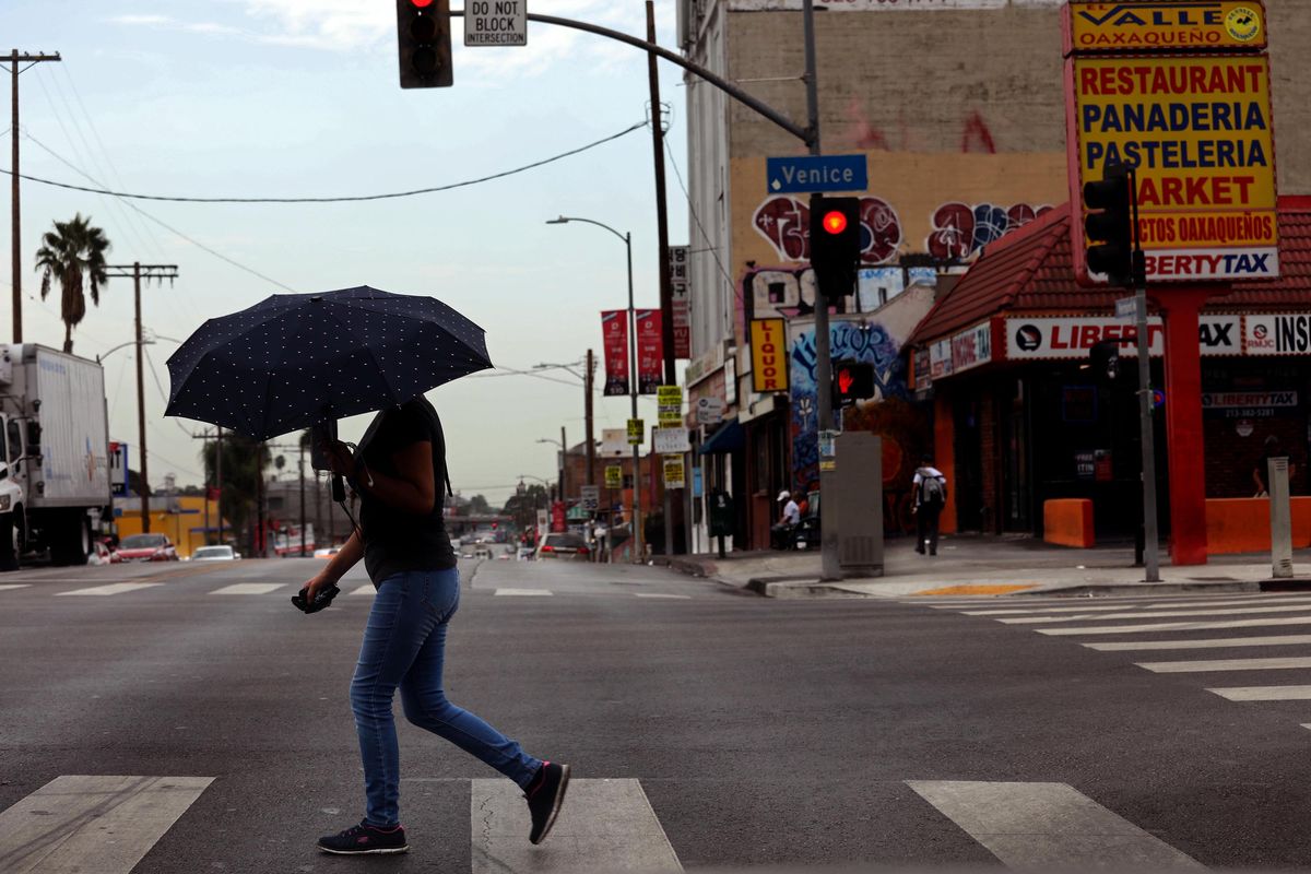 A pedestrian breaks out the umbrella as rain falls in Los Angeles on Thursday, with more of the same on the way as Tropical Storm Kay moves into the area.  (Genaro Molina/Los Angeles Times/TNS)