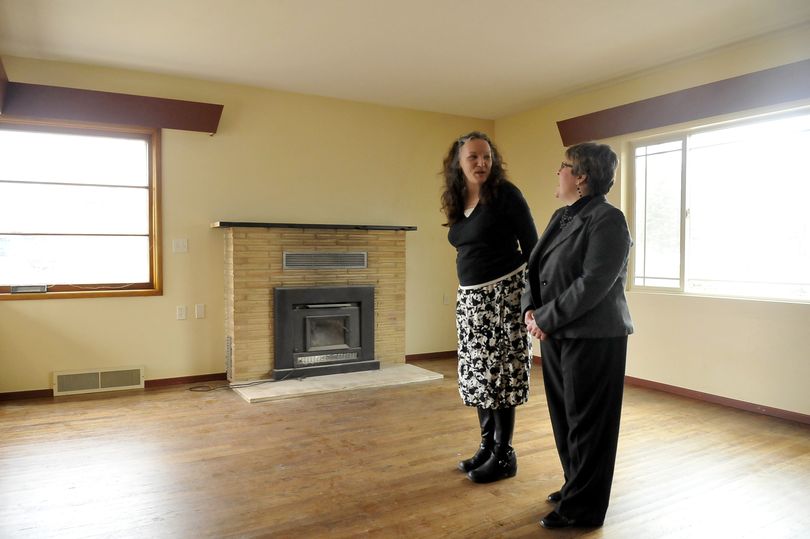 Karen Fournier, left, and Jane Murphy of Hearth Homes stand in the living room of the newest transitional home the group will open in Spokane Valley, Thursday. Hearth Homes runs a series of homes for women with children. Fournier is the group’s executive director, and Murphy is the development director. (Jesse Tinsley)