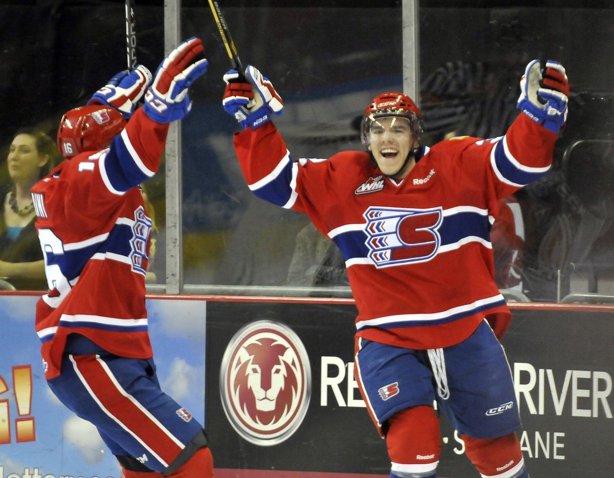 Spokane’s Todd Fiddler, right, celebrates after he scored a short-handed goal to tie the game at 1 in the first period. (Jesse Tinsley)