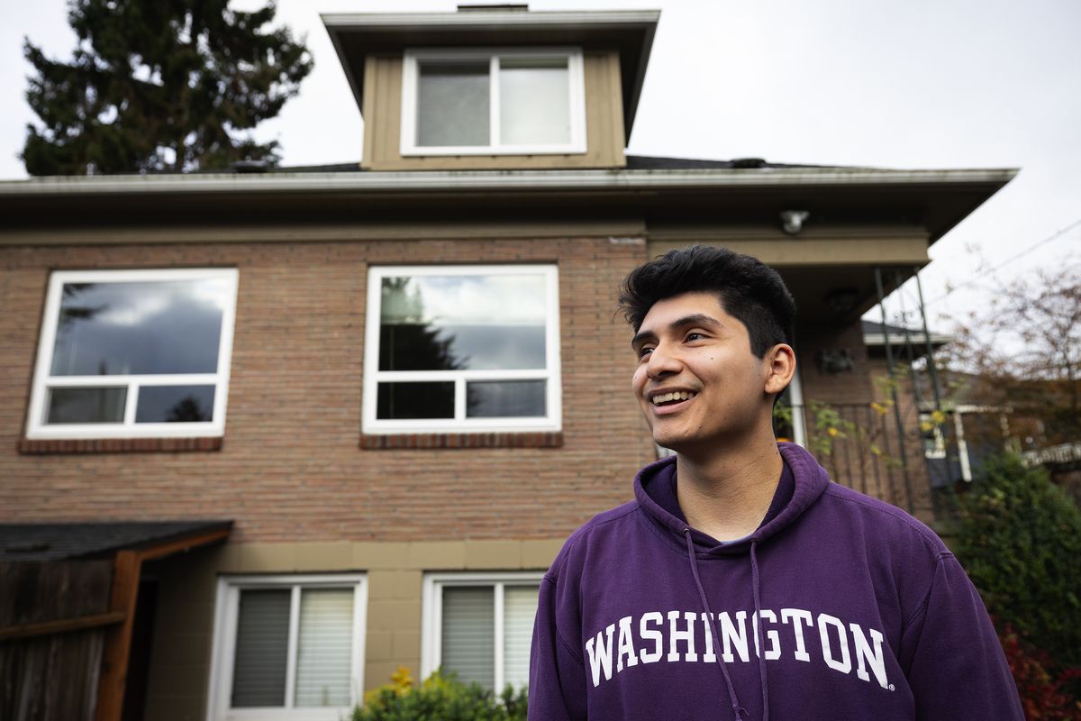 Edwin Nino Delgado outside his first home purchase, a triplex with rooms to rent to help pay the mortgage, on Oct. 27 in Seattle.  (Ken Lambert)