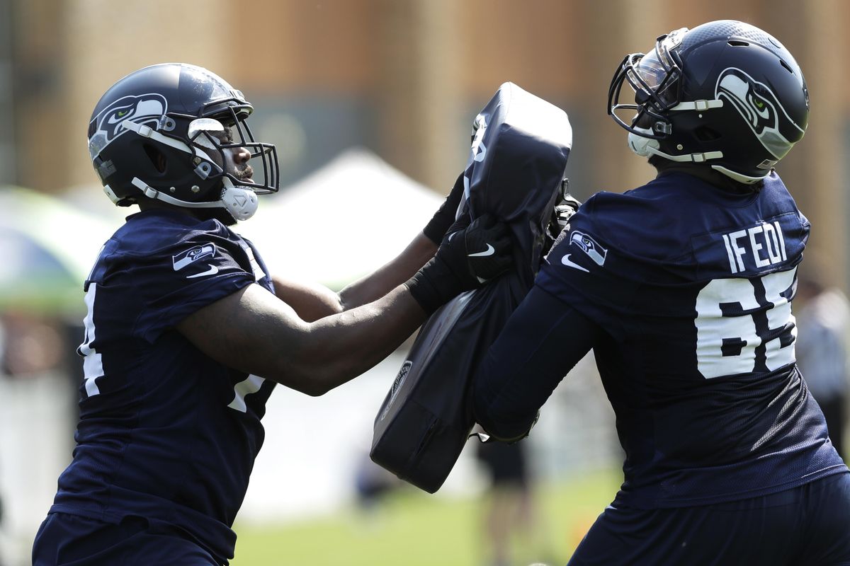 Seattle Seahawks offensive guard Germain Ifedi  squares off against offensive tackle George Fant, left, during  training camp Aug. 6 in Renton, Wash. (Ted S. Warren / AP)