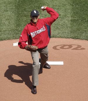 President Barack Obama, wearing a Washington Nationals jacket and a Chicago White Sox hat, delivers the ceremonial first pitch during opening day ceremonies for a baseball game between the Philadelphia Phillies and Washington Nationals, Monday, April 5, 2010, at Nationals Park in Washington. (Pablo Monsivais / Associated Press)
