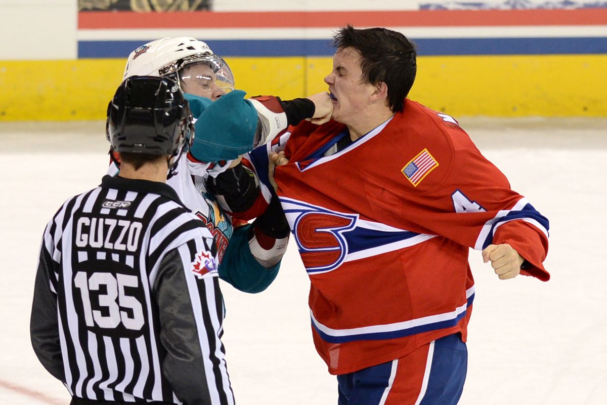 Jeremy McIntosh, right, mixes it up with the Kelowna’s Riley Stadel in the third period. (Jesse Tinsley)