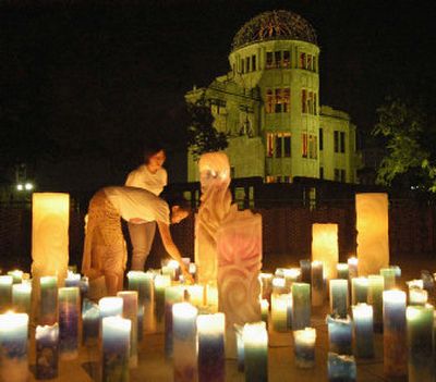 
Women light candles in front of the Atomic Bomb Dome early today in Hiroshima, praying for the world peace and repose of the victims of the world's first nuclear bombing.
 (Associated Press / The Spokesman-Review)