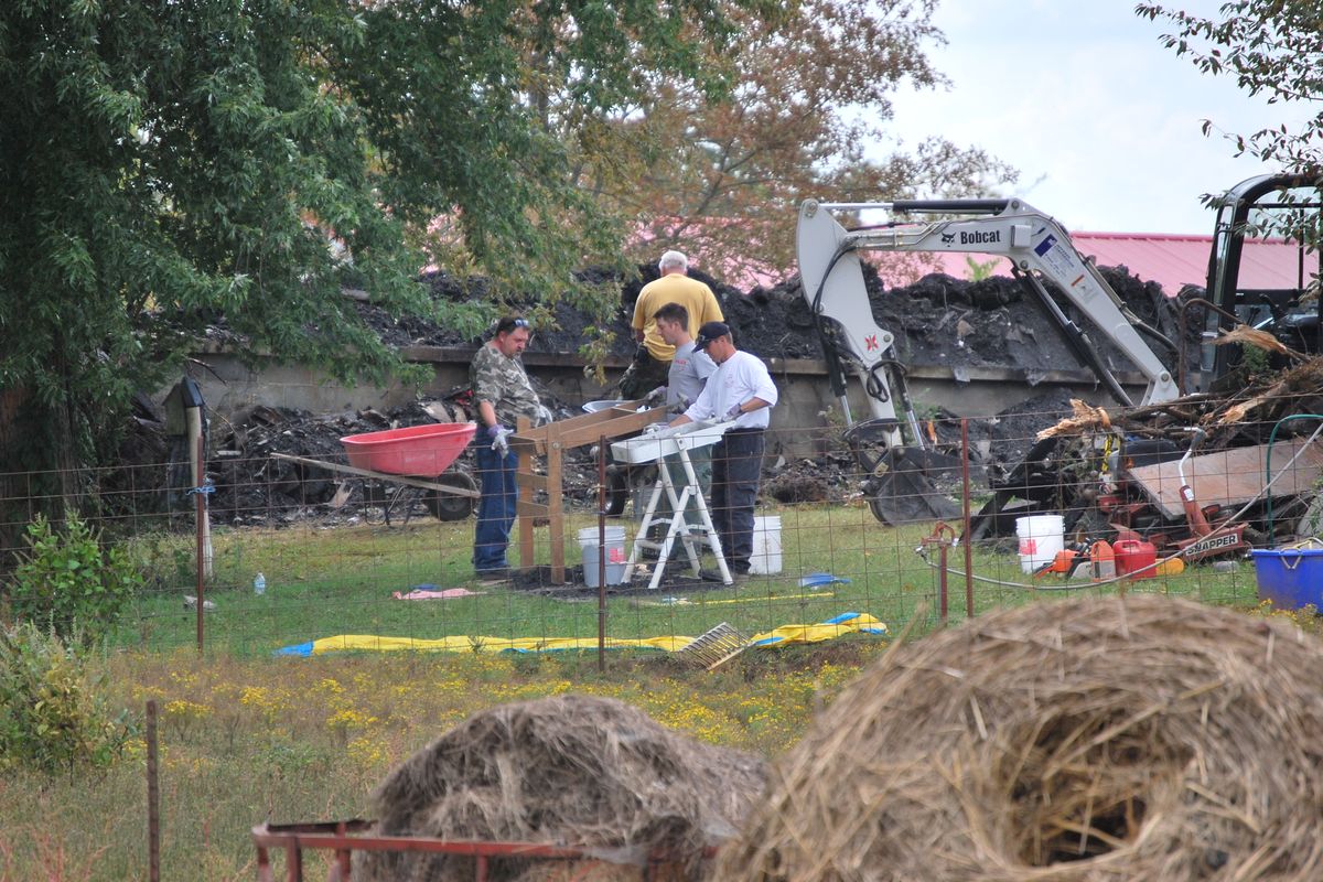 Workers are still on the job Thursday, Sept. 27, 2012, near Shelbyville, Tenn., at the site of a house fire that where an elderly couple and two young children lived. Authorities were searching the debris for the remains of the two missing children, 9-year-old Chloie Leverette and 7-year-old Gage Daniel. The two children were initially believed to have perished in the intense fire, which firefighters battled overnight Sunday and early Monday. (Kristin Hall / Associated Press)
