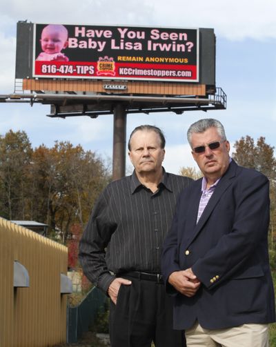 Roger Kemp, left, and Bob Fessler, vice president and general manager of Lamar Advertising, pose Thursday near an electronic billboard in Kansas City, Mo. (Associated Press)