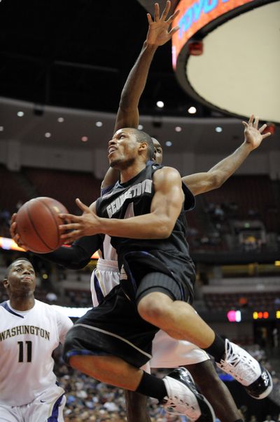 Georgetown’s Chris Wright goes up for a shot against the Huskies in second half.  (Associated Press)