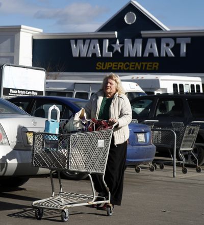 A shopper makes her way to her car at Walmart in Brunswick, Maine, on Thursday. Wal-Mart Stores Inc., one of the recession’s biggest beneficiaries, felt the pinch during the fourth quarter as sales fell at U.S. Walmart stores for the first time. (Associated Press)