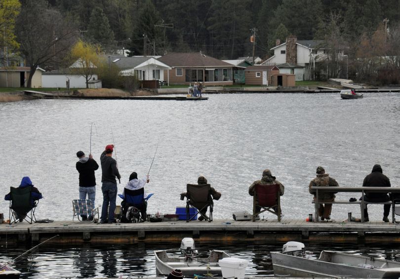 Fish on! Anglers get some action from the dock of Klink's Williams Lake Resort on the opening day of Washington's lowland lake fishing season. (Rich Landers)